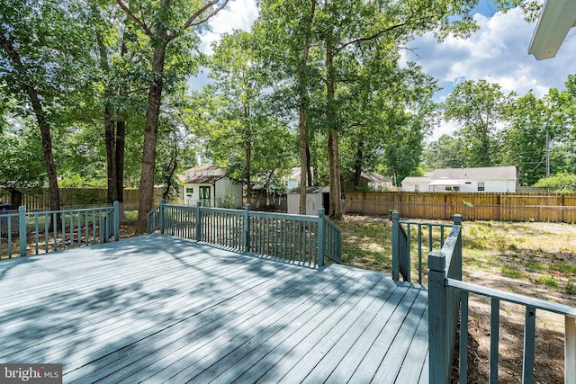 wooden deck featuring a shed