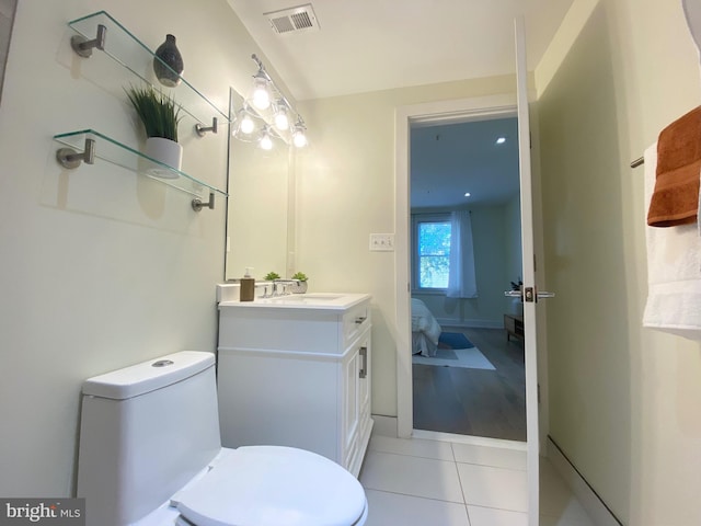 bathroom with tile patterned flooring, vanity, and toilet