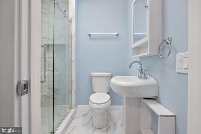 bathroom featuring toilet and a shower with shower door