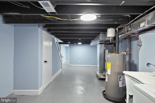 basement with independent washer and dryer and electric water heater