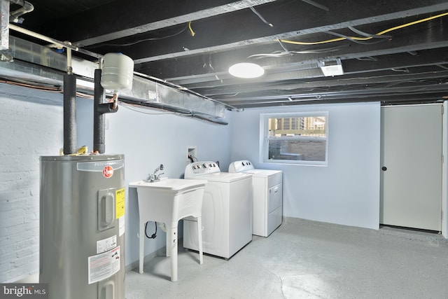 laundry room with washing machine and clothes dryer and water heater