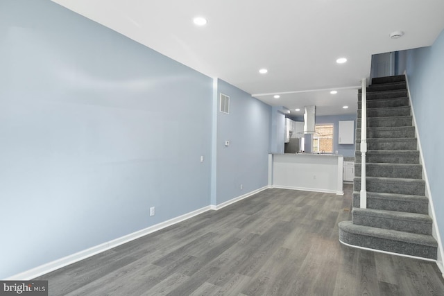 unfurnished living room featuring dark hardwood / wood-style flooring