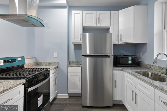 kitchen with white cabinets, black appliances, sink, dark hardwood / wood-style floors, and wall chimney range hood