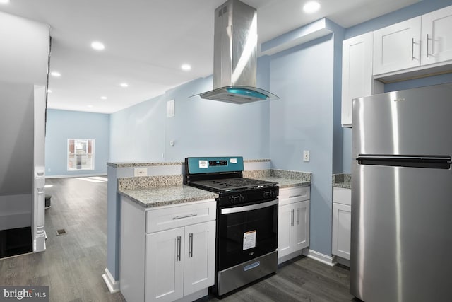 kitchen featuring dark wood-type flooring, range hood, appliances with stainless steel finishes, and white cabinets