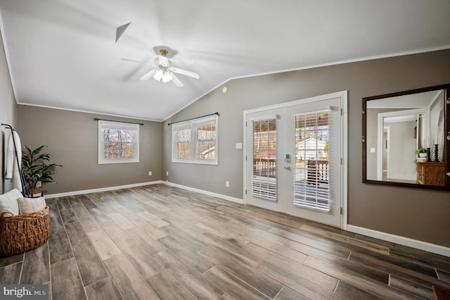 living room featuring french doors, ornamental molding, ceiling fan, hardwood / wood-style floors, and lofted ceiling