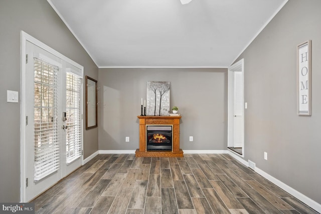 unfurnished living room with lofted ceiling, dark hardwood / wood-style flooring, and ornamental molding