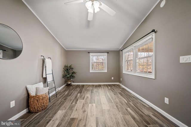 unfurnished room featuring ceiling fan, wood-type flooring, ornamental molding, and lofted ceiling