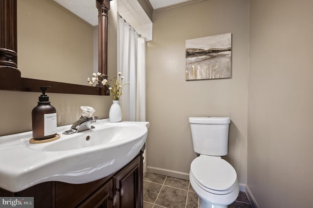 bathroom with tile patterned flooring, vanity, toilet, and crown molding