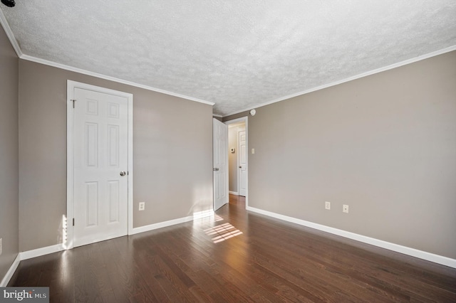 empty room with ornamental molding, a textured ceiling, and dark wood-type flooring