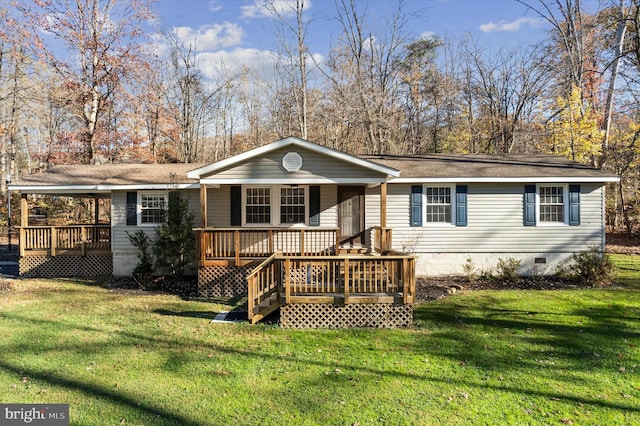 rear view of house with a lawn and a deck