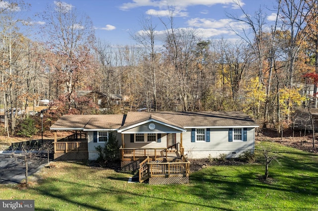 back of house with a deck and a yard