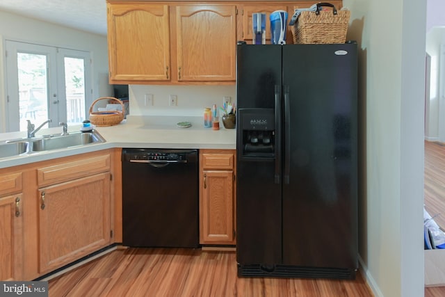 kitchen with sink, french doors, light wood-type flooring, and black appliances