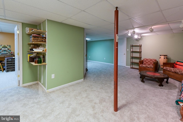 basement featuring light carpet and a drop ceiling