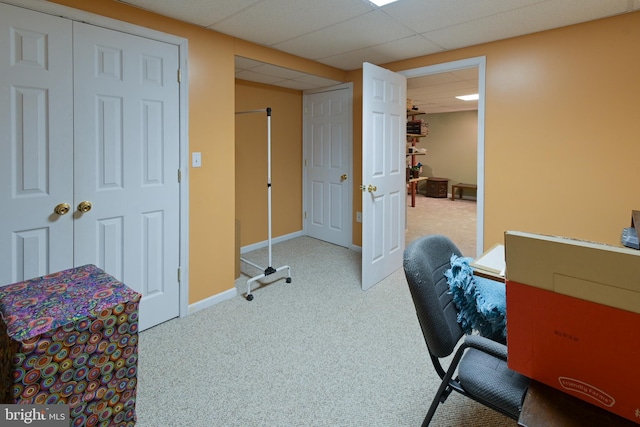 carpeted home office with a drop ceiling