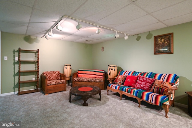 living room featuring a paneled ceiling, carpet floors, and track lighting