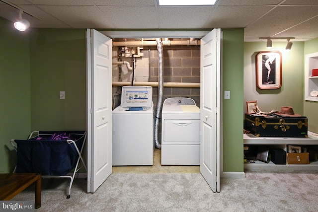 laundry room with washing machine and dryer, light carpet, and track lighting