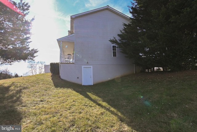 view of side of home featuring a yard