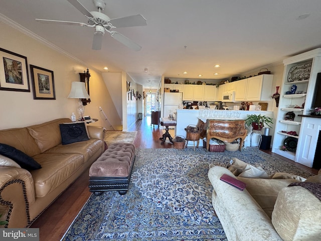 living room with ornamental molding, hardwood / wood-style flooring, and ceiling fan