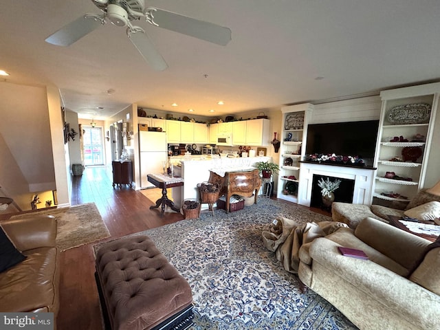 living room with dark wood-type flooring and ceiling fan