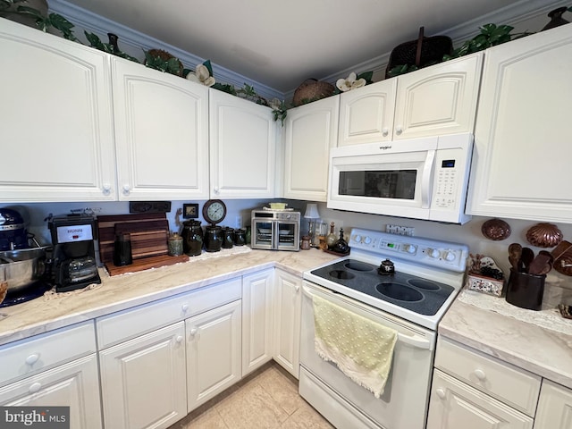 kitchen featuring white cabinets, white appliances, light tile patterned floors, and ornamental molding