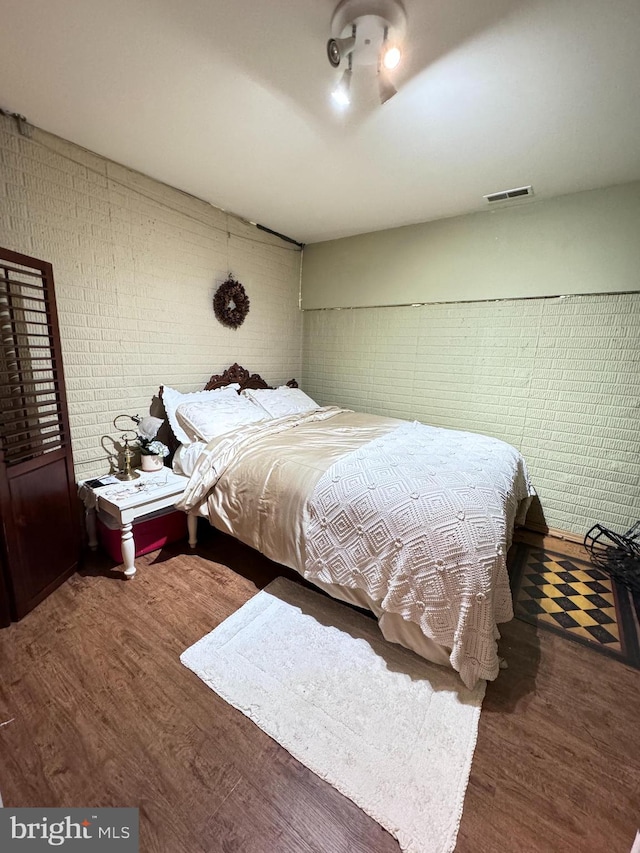 bedroom with hardwood / wood-style flooring