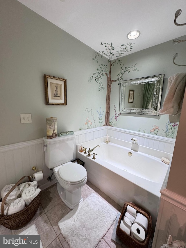 bathroom with toilet, tile patterned floors, and a bathing tub