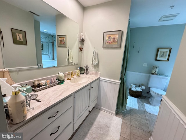 bathroom featuring tile patterned floors, vanity, and toilet