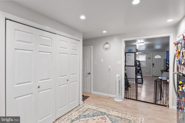 foyer entrance featuring ceiling fan and light hardwood / wood-style flooring