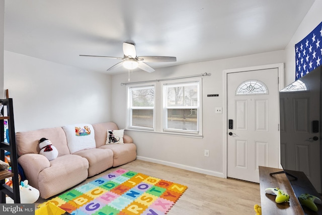 living room featuring ceiling fan and light hardwood / wood-style flooring