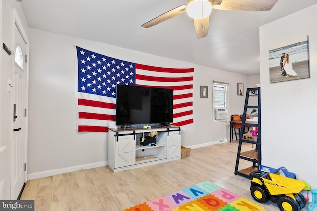 playroom featuring hardwood / wood-style floors, ceiling fan, and cooling unit