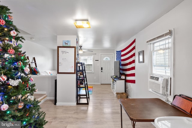 entryway featuring ceiling fan, light hardwood / wood-style floors, and cooling unit