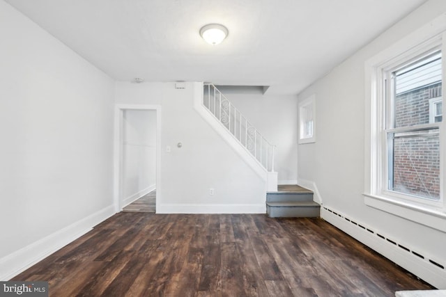 unfurnished room featuring dark hardwood / wood-style floors and a baseboard radiator