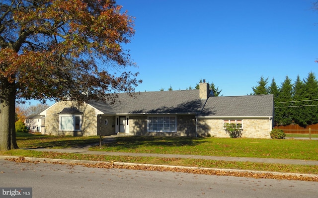 ranch-style home with a front lawn