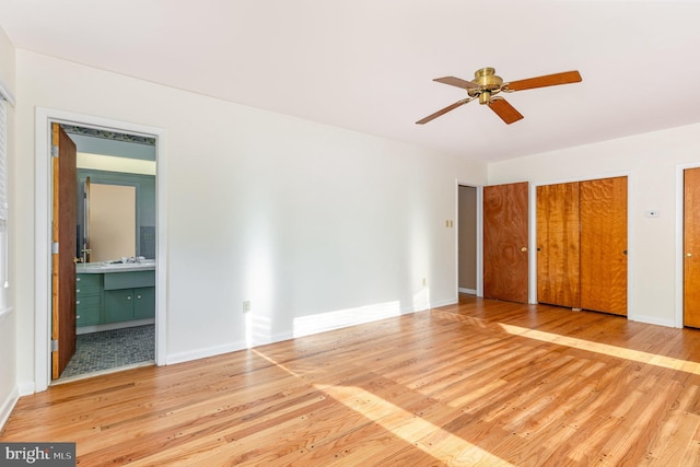 unfurnished bedroom featuring ceiling fan, connected bathroom, and light hardwood / wood-style flooring