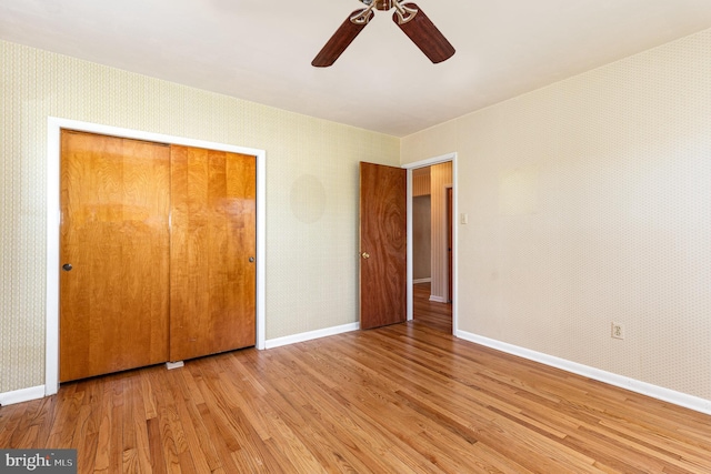 unfurnished bedroom featuring light wood-type flooring, a closet, and ceiling fan