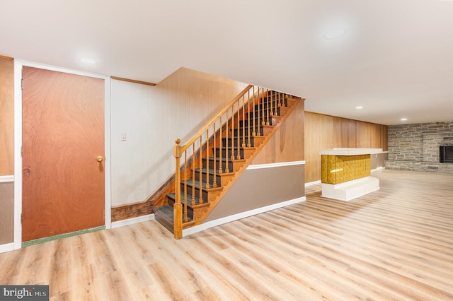 interior space featuring wood-type flooring and wood walls