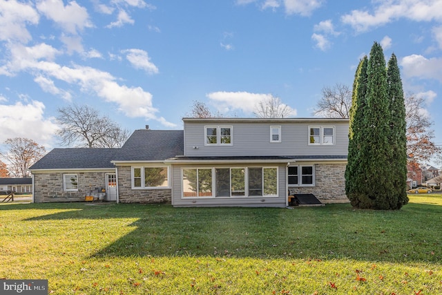 rear view of property with a lawn