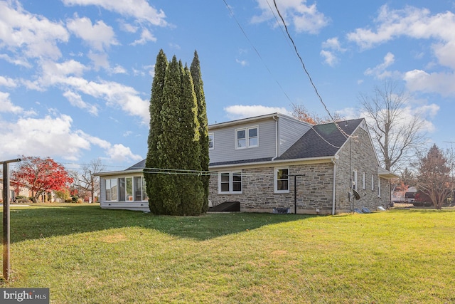 rear view of property with a lawn