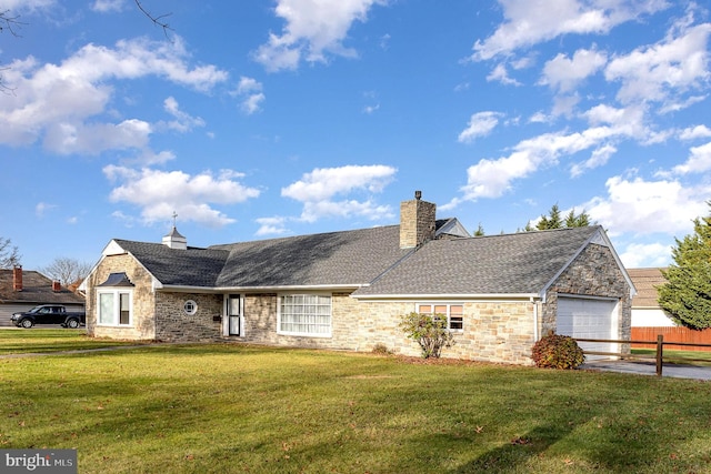 single story home with a front yard and a garage