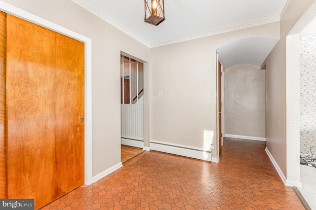 interior space featuring baseboard heating and ornamental molding