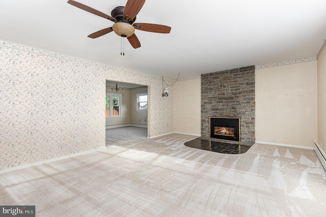 unfurnished living room with carpet, ceiling fan, and a stone fireplace