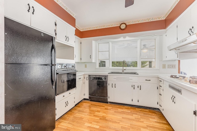 kitchen featuring black appliances, white cabinetry, and light wood-type flooring