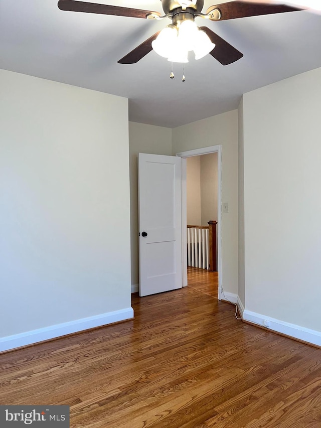 spare room with hardwood / wood-style flooring and ceiling fan