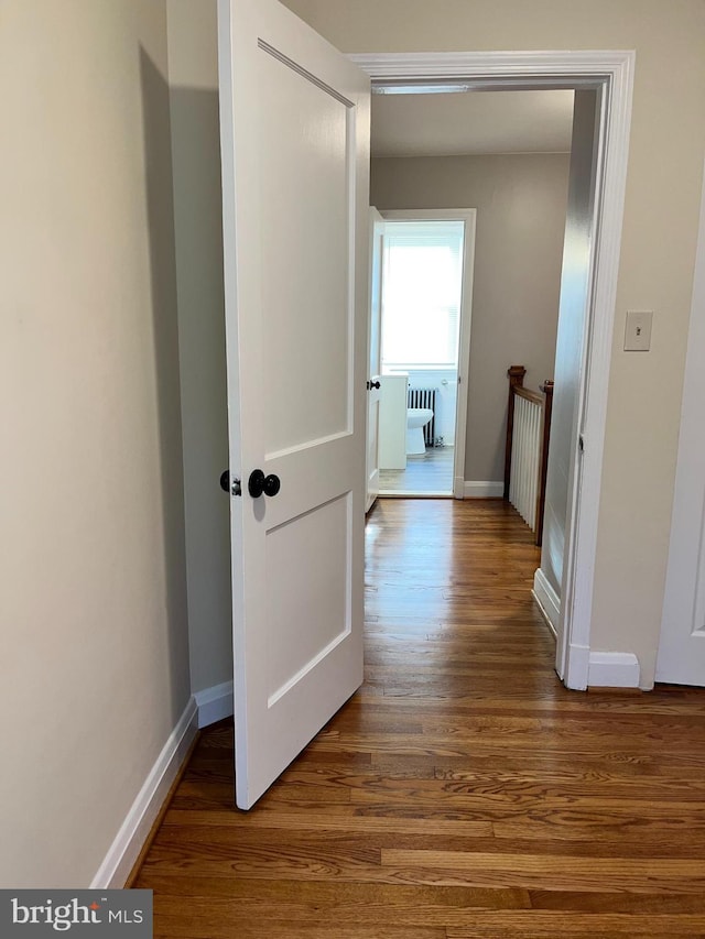 corridor featuring wood-type flooring