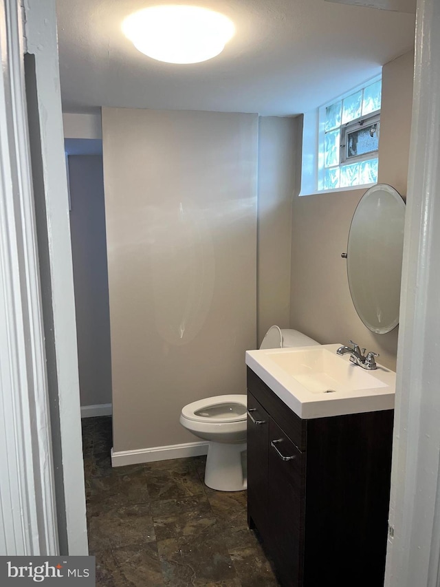 bathroom with toilet and vanity