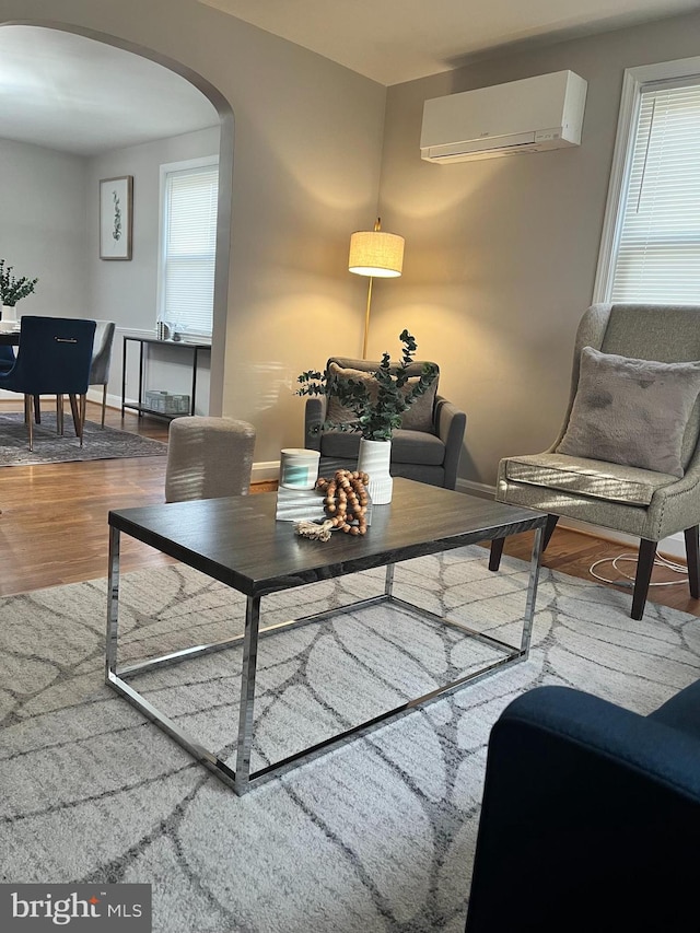 interior space featuring a wall unit AC and hardwood / wood-style flooring