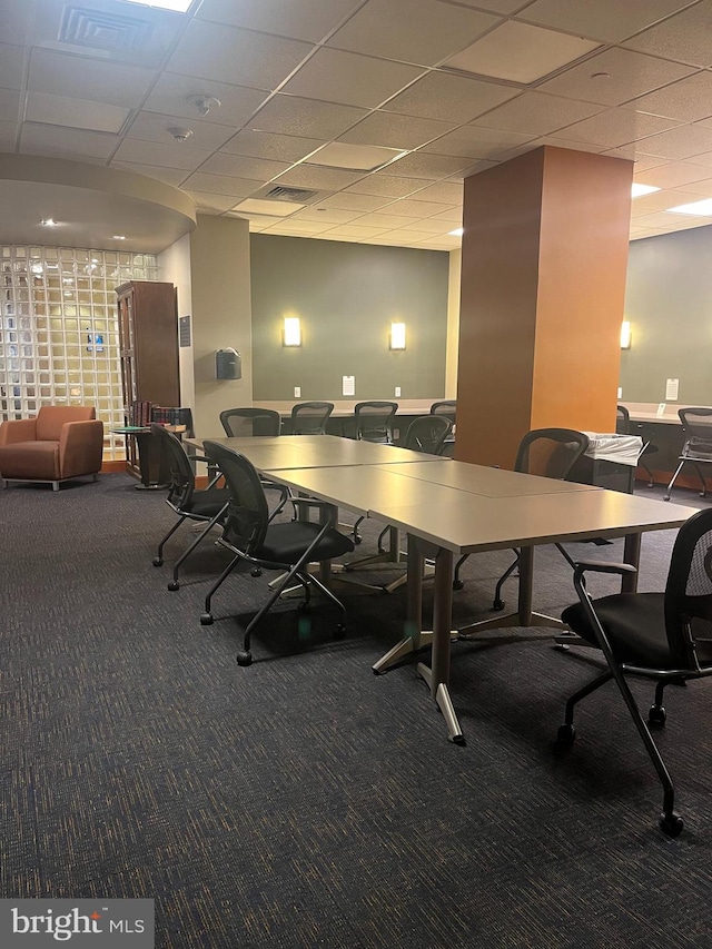 carpeted office space with a drop ceiling