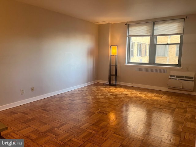 empty room with a wall mounted air conditioner and parquet flooring