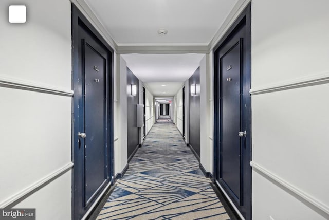 corridor featuring dark colored carpet