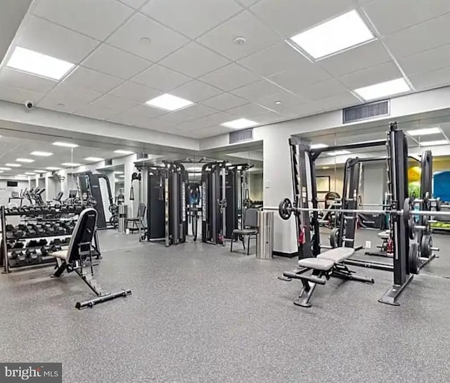 workout area with a paneled ceiling